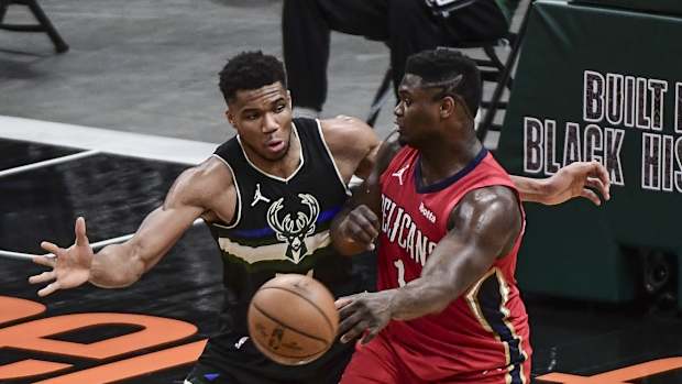 Milwaukee Bucks forward Giannis Antetokounmpo (34) pressures New Orleans Pelicans forward Zion Williamson (1)